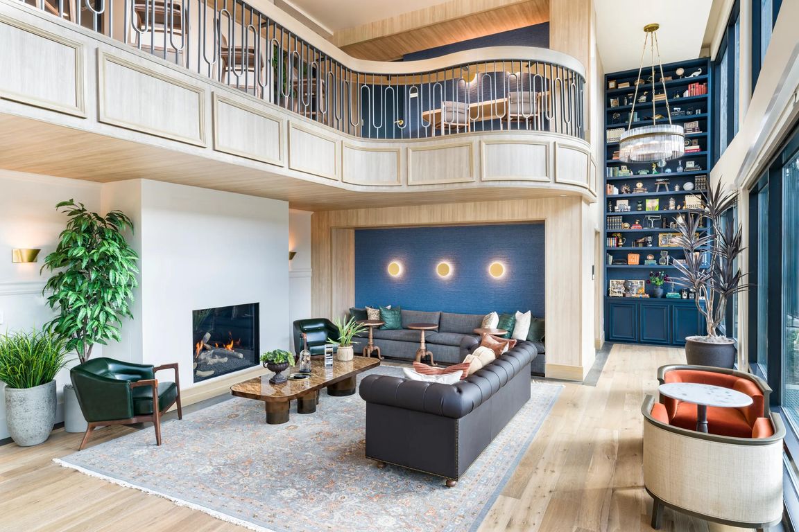 Expansive clubroom with fireplace and lounge seating at Modera University Park.