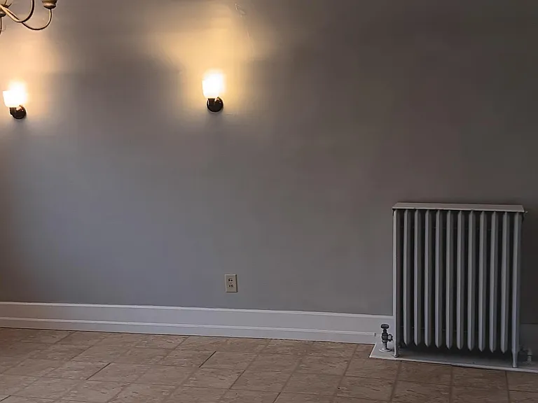 Kitchen wall opposite sink.