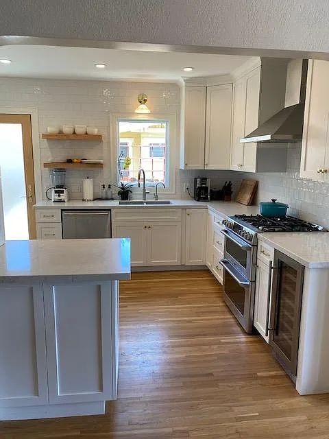 GE Cafe stove/double oven and hood next to wine fridge - 2824 Dale St