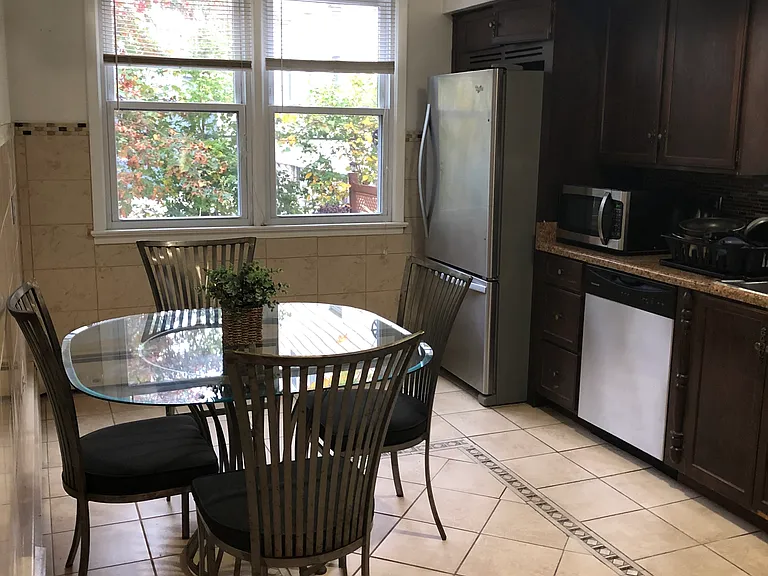 Large eat in kitchen overlooking backyard, ample cabinets for storage
