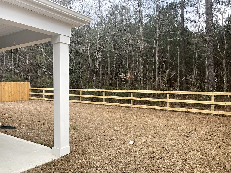 Backyard with fence and wooded open space