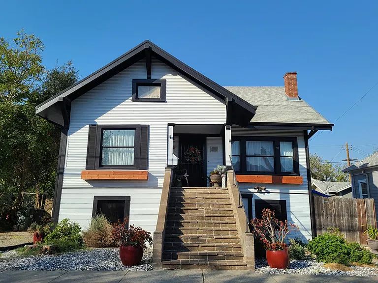 Front, drought tolerant landscaping. Long driveway to the left to fit two cars. Nice porch from which to enjoy the July 4th Fireworks!
