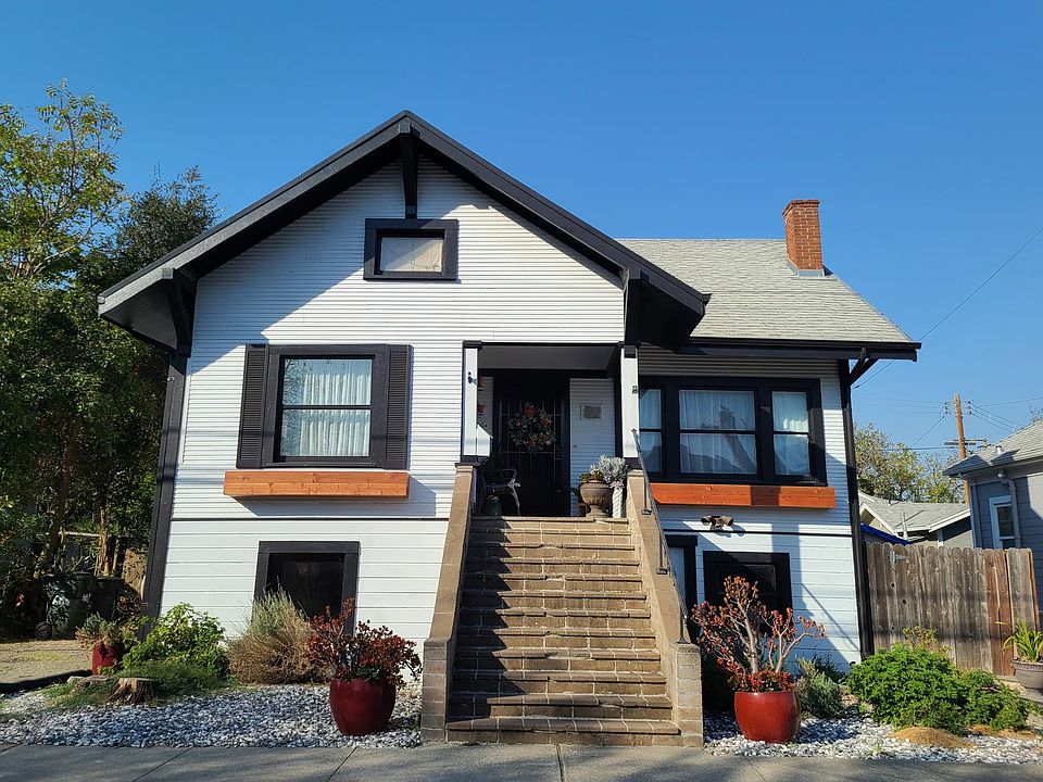 Front, drought tolerant landscaping. Long driveway to the left to fit two cars. Nice porch from which to enjoy the July 4th Fireworks!