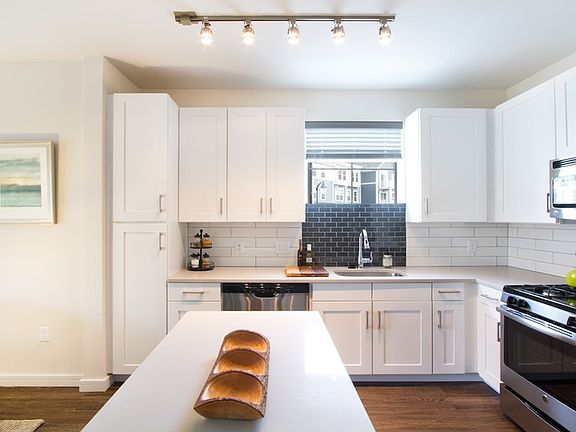 Quartz countertops, stainless steel appliances and custom cabinets in our contemporary kitchens