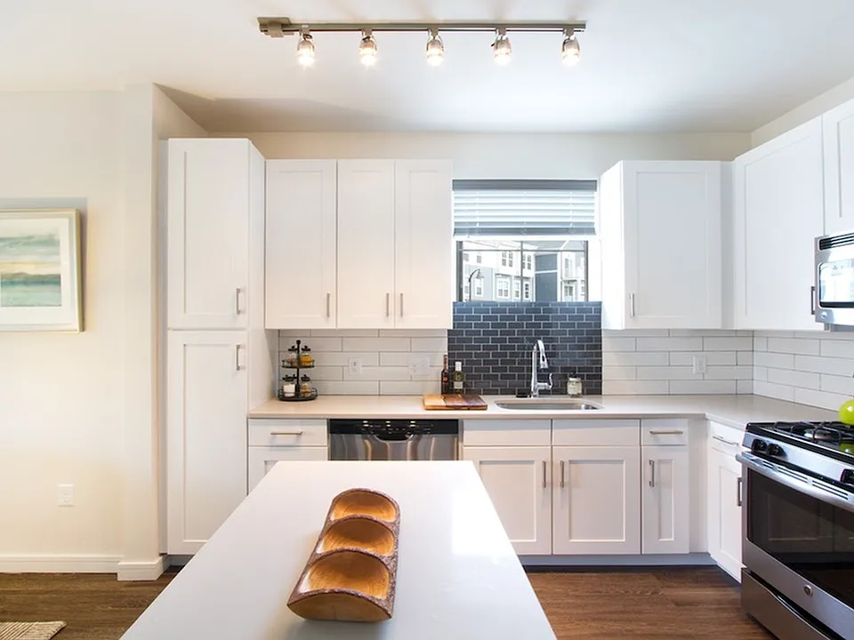 Quartz countertops, stainless steel appliances and custom cabinets in our contemporary kitchens