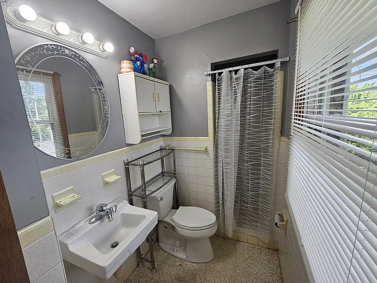 Main bedroom bath upstairs with walk in tile shower.