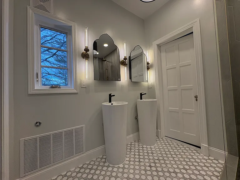 View of double, freestanding pedestal sinks