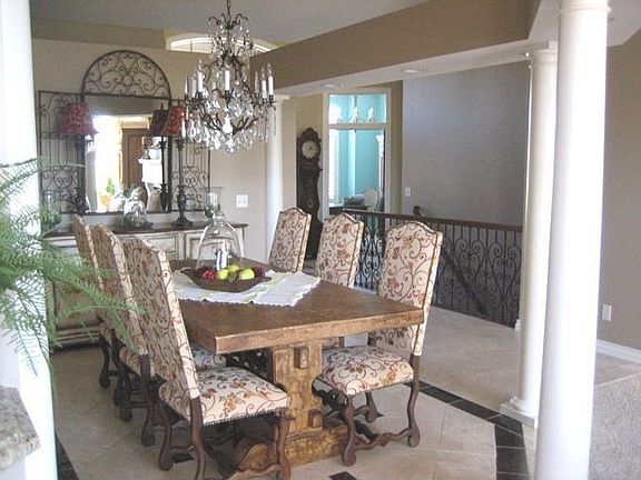 Formal dining area defined by 4 columns and travertine flr with marble inlays!