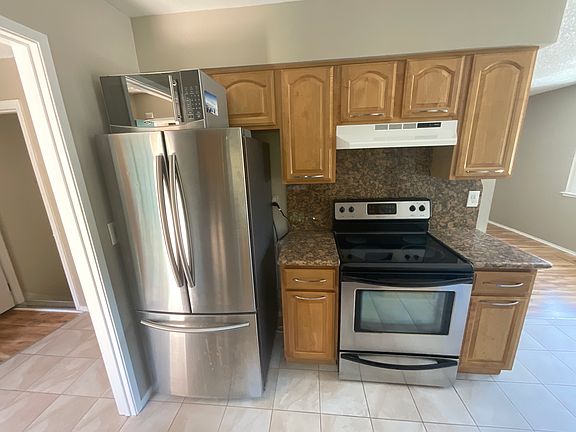 Modern kitche with stainless steel appliances double door Frig, Microwave, and dishwasher