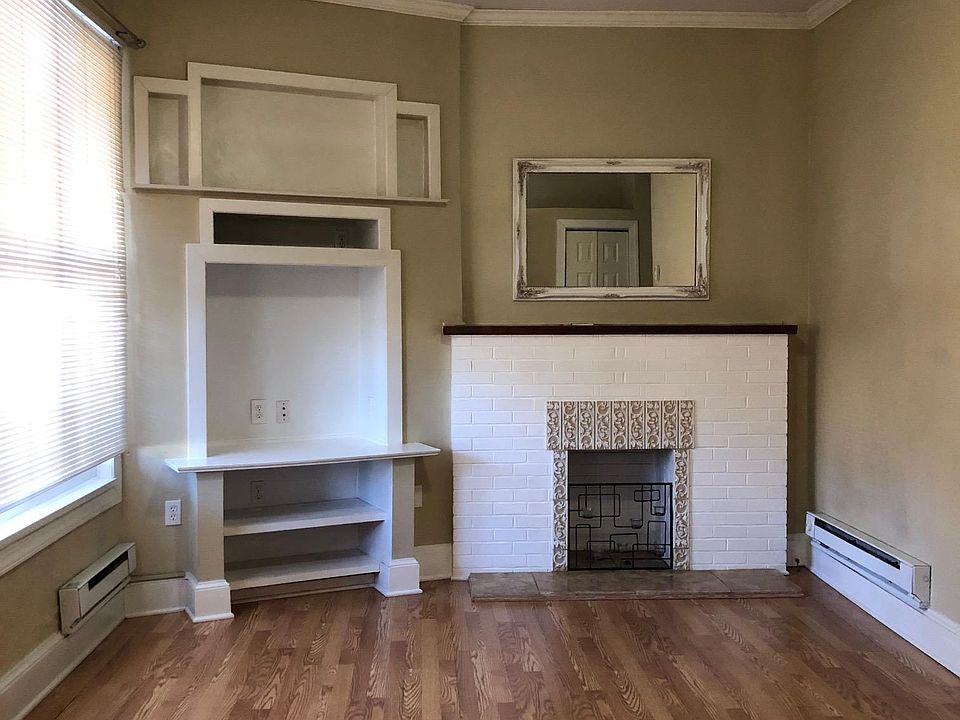 Living Room with built-in shelves, great natural light and faux fireplace