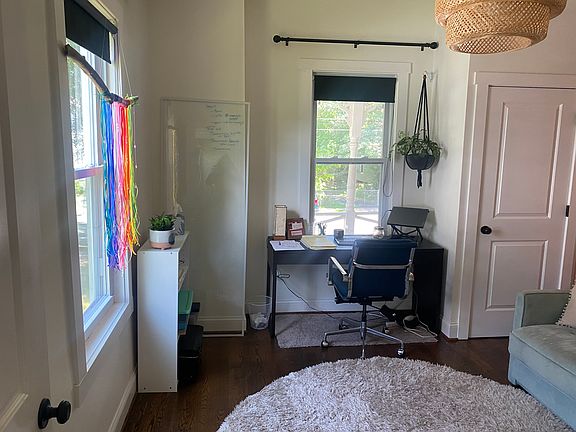 Desk facing out to sunny porch in window alcove