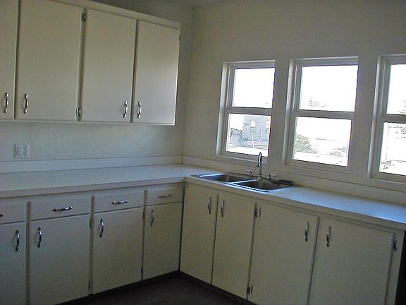 Upstairs kitchen windows flood the living area with light.