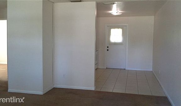 Livingroom looking into kitchen on right and bedrooms on lef