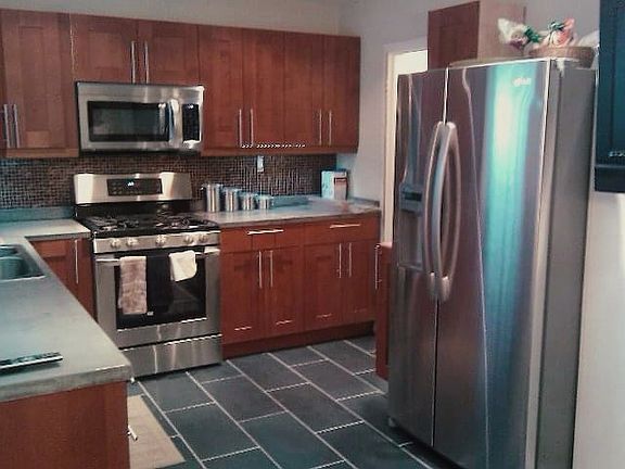 The kitchen includes stainless steel appliances, though they may not be identical to those shown in the picture.