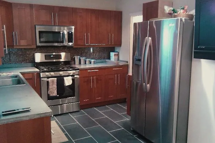 The kitchen includes stainless steel appliances, though they may not be identical to those shown in the picture.