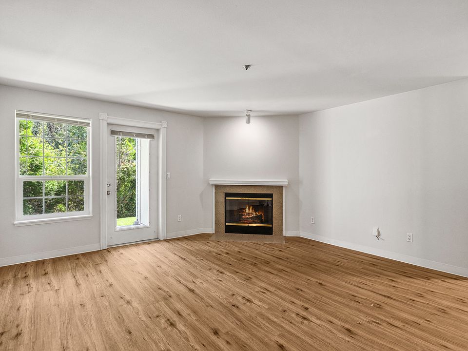 Cozy living room with fireplace and natural light.