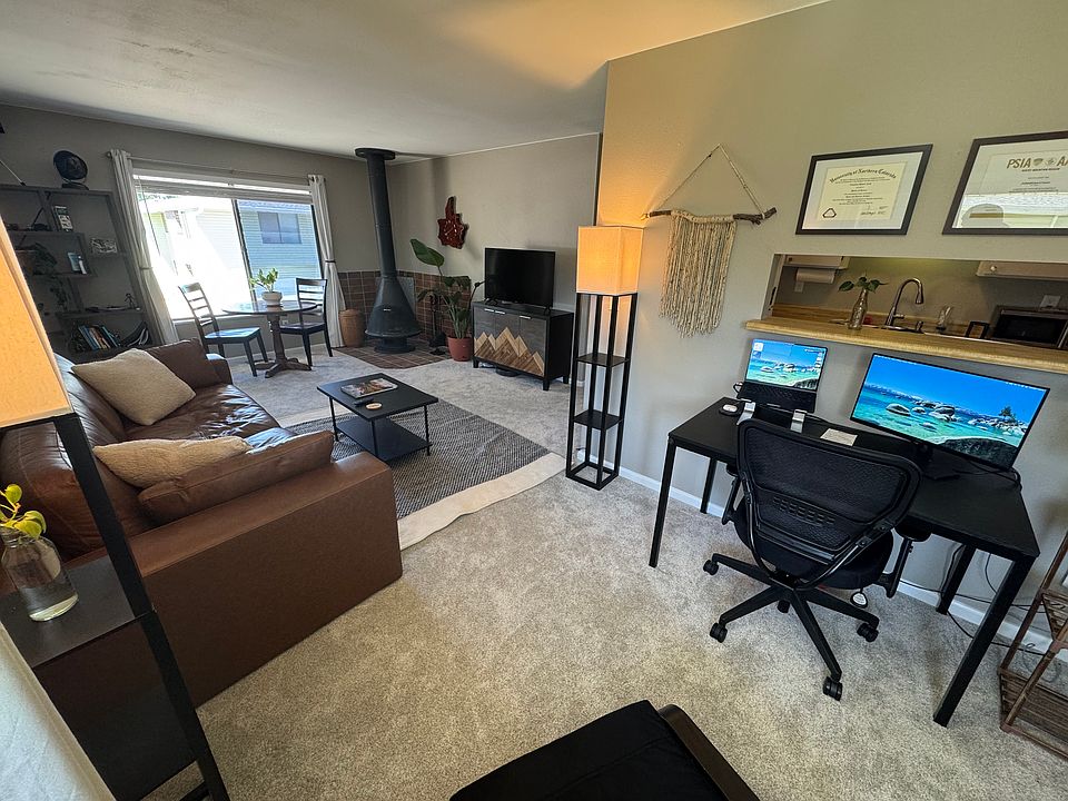 Living room opens into a dining room/office nook, which is has a serving window to the kitchen