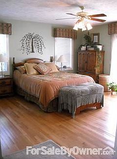 Light-filled master BR with hardwood floors, walk-in closet, & master bath.