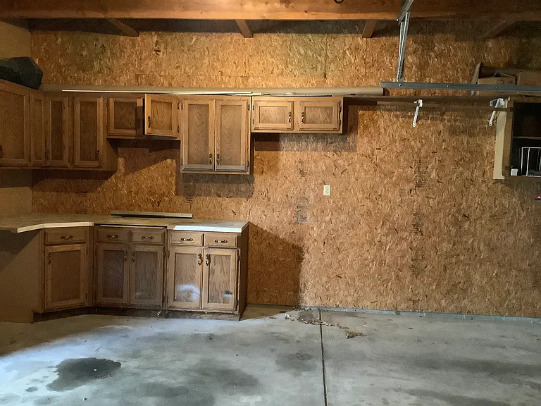 North wall in the garage has a lot of nice cabinets for storage galore