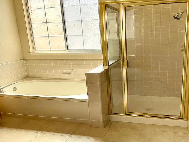 Enjoy large bath tub and separate shower with bright sunny light