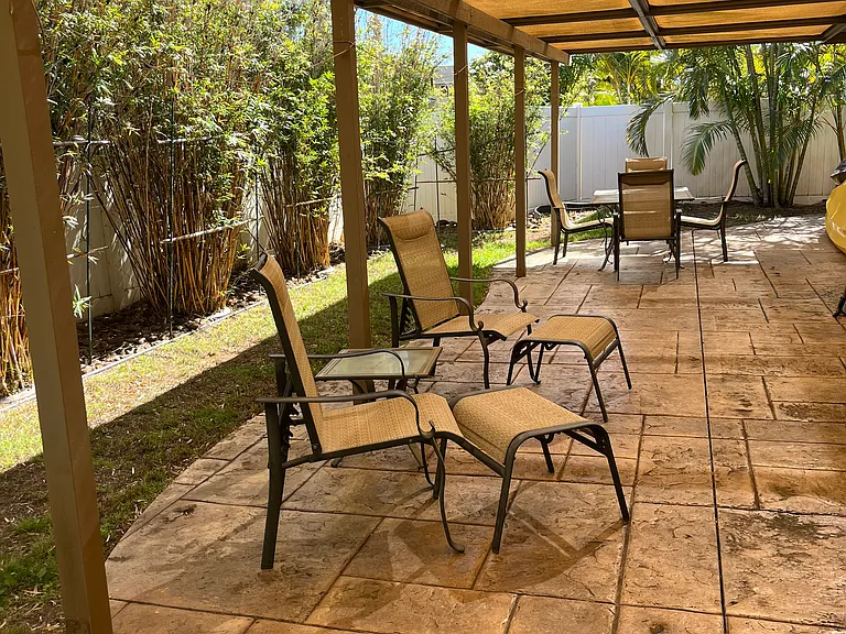 Outdoor covered lanai with patio furniture