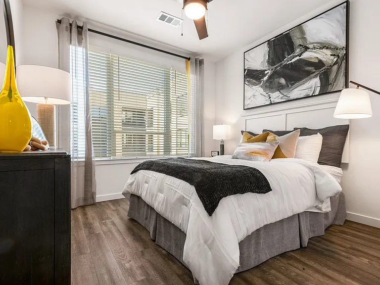 Bright Bedroom with Large Windows and Designer Lighting Fixtures