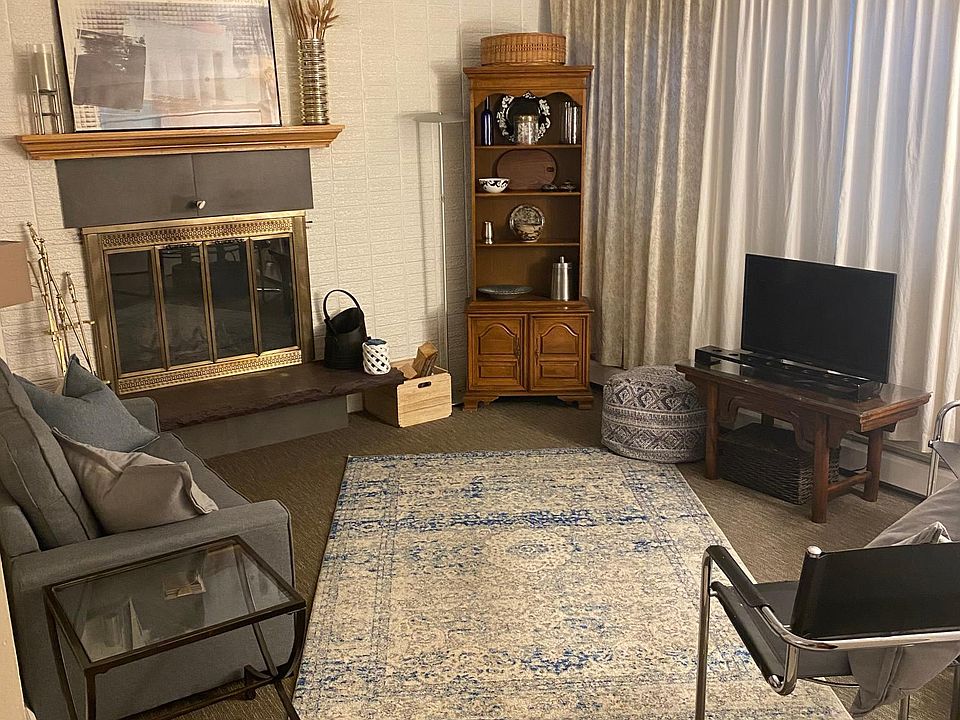 Furnished living room with fireplace.
