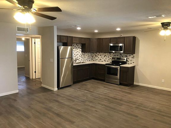 Great room and view to kitchen. The unit has 4 new oil bronzed cieling fans.