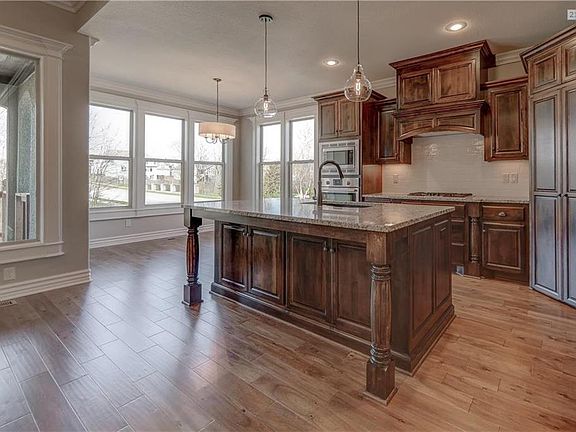 European soft close drawers, custom crafted alder cabinetry, generously sized work island and granite countertops.