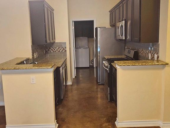 You also see the separate utility room where the washer, dryer, and clothing rake are located.