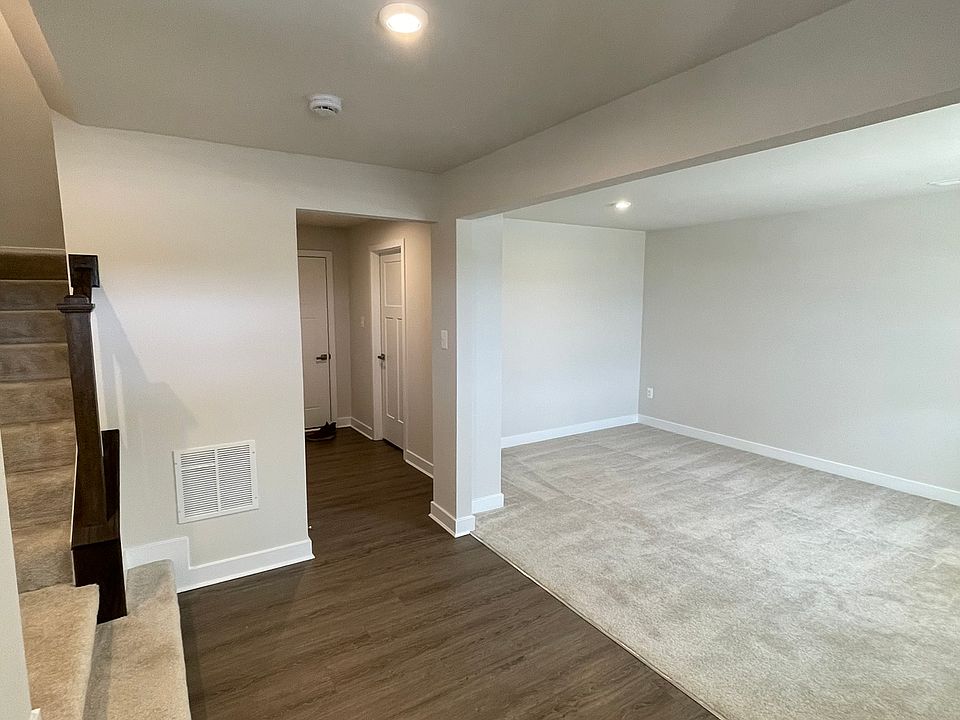 Entry Level/1st Floor Foyer with view of stairs, hallway to garage, and Multipurpose room