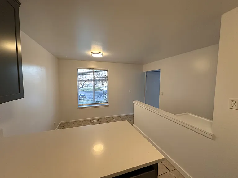 View of Dining Area, Stairway to Two Bedrooms & Full Bathroom (Shower no Tub) Downstairs
