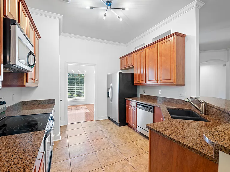 The kitchen offers a bar seating and direct access to both the formal dining room and breakfast room.