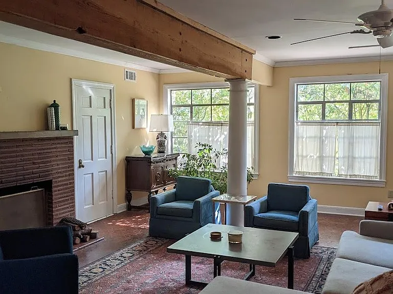 Downstairs Great Room - 20ft x 28ft _ with Wood Burning Fireplace & White Wooden Columns.