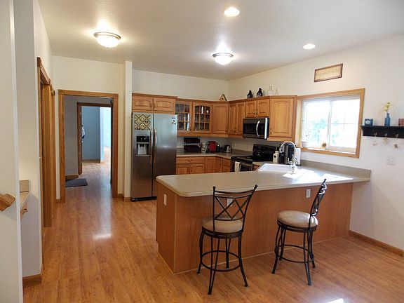The kitchen boasts new stainless steel appliances, plenty of cabinet space, and beautiful flooring.