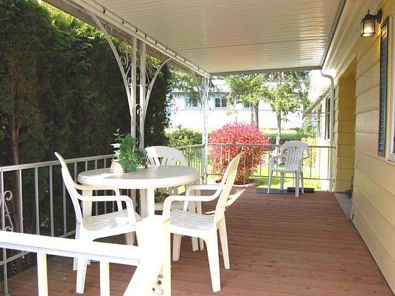 Entertain here with this beautiful updated porch.