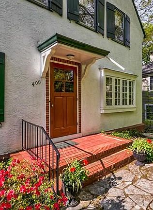 A welcoming entry with a brick front porch and brick detailing a