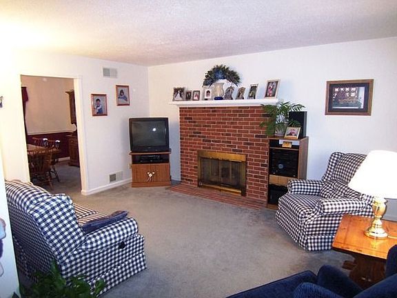 Brick fireplace w/gas logs enhances living rm