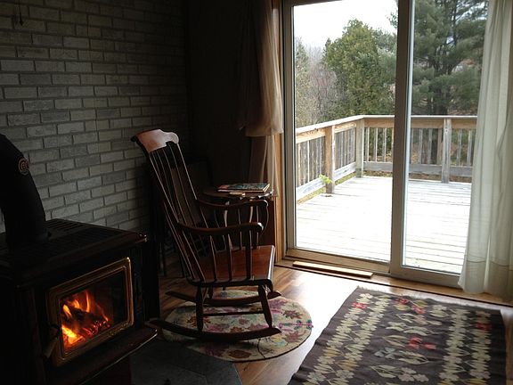 Den with woodstove and deck.