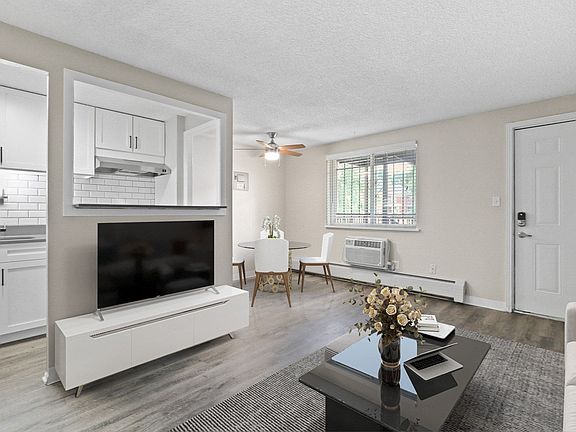 Smart open-concept layout connects living and dining with bright windows and stylish finishes
