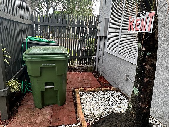 Fenced in front area with storage shed