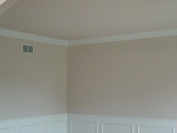Arched doorways in Living Room with white trim package