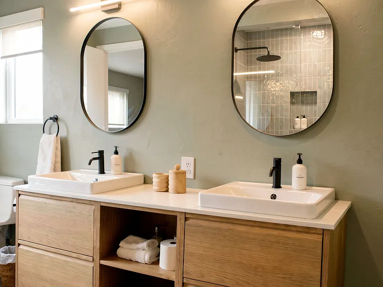 Spacious double-sink bathroom with modern fixtures and generous storage_ideal for shared living.