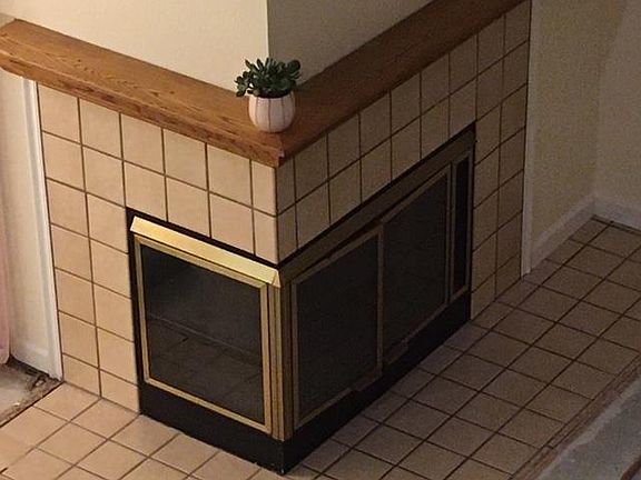 Wood burning fireplace with tile surround and solid oak mantel