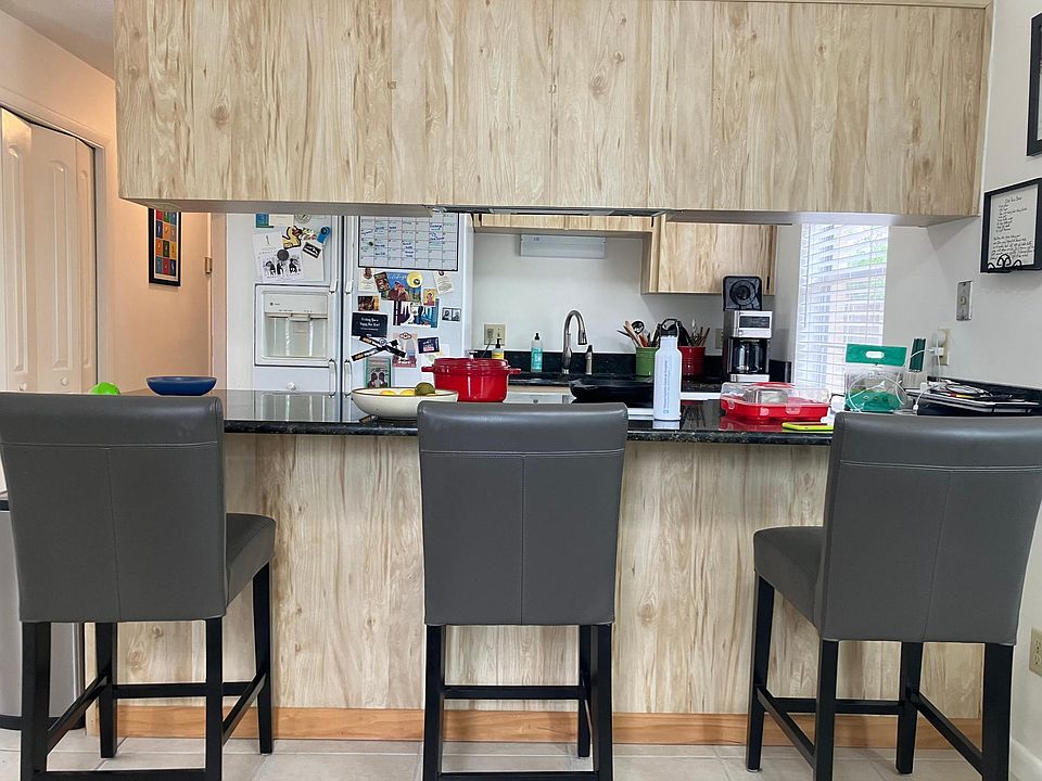 Lots of cabinet space, granite counter tops and bar separating kitchen from dining area.