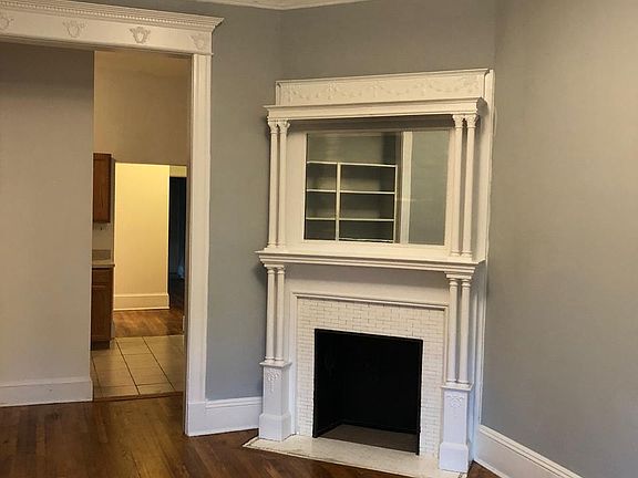 Another photo of built in fireplace in front living room looking towards kitchen and hallway beyond kitchen.