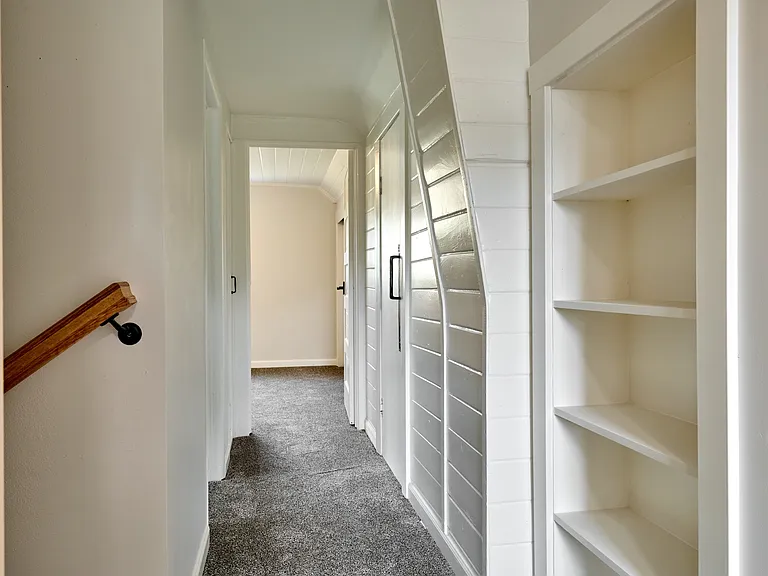 Upstairs Hallway includes both a small linen closet and a larger carpeted storage closet with benches (kids love it)