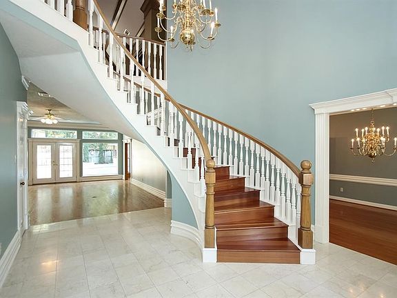 As you enter the home you will notice the marble tile entry and the spiral staircase. To the left as you enter the home is the formal sitting room and to the right is the formal dining.