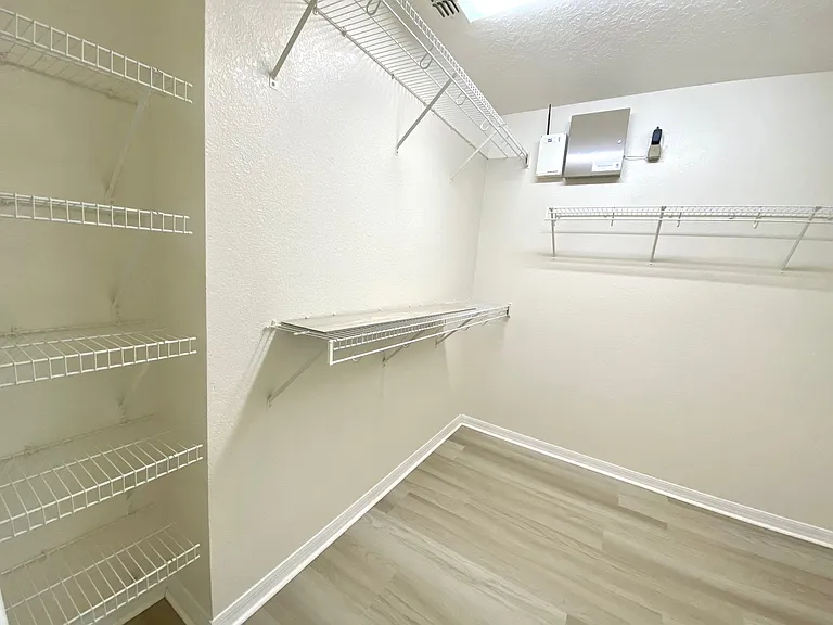Large walk in closet with shelves