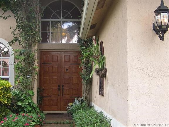 Double door entrance. Lush landscaping.